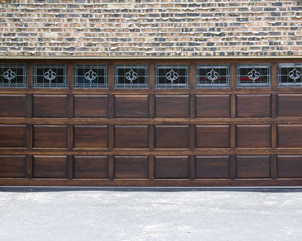 brown wood garage door with decorative windows belle mo