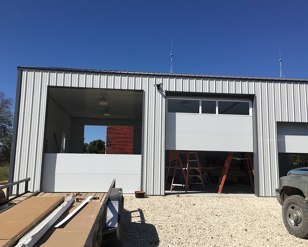 garage doors being installed on commercial building belle mo